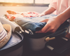 Packing travel essentials in a suitcase for a vacation
